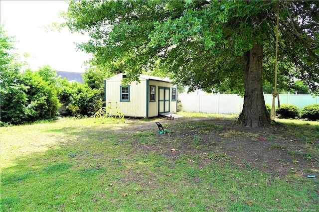 view of yard with a storage shed and an outbuilding