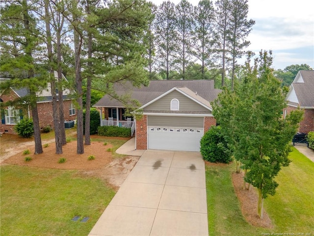 3119 Metthame Dr, Fayetteville, NC 28306 - view of front of house with driveway, brick siding, an attached garage, a porch, and a front lawn