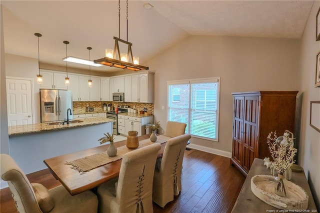 3119 Metthame Dr, Fayetteville, NC 28306 - dining room featuring dark wood-style floors, baseboards, and vaulted ceiling