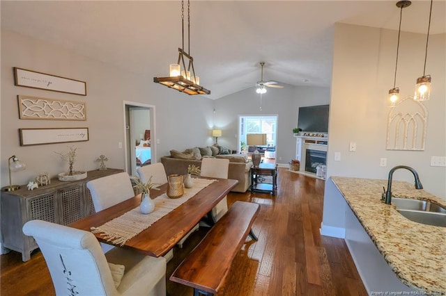 3119 Metthame Dr, Fayetteville, NC 28306 - dining area with a ceiling fan, lofted ceiling, dark wood-type flooring, baseboards, and a fireplace