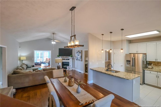 3119 Metthame Dr, Fayetteville, NC 28306 - dining room with a ceiling fan, lofted ceiling, light wood-style floors, and a fireplace