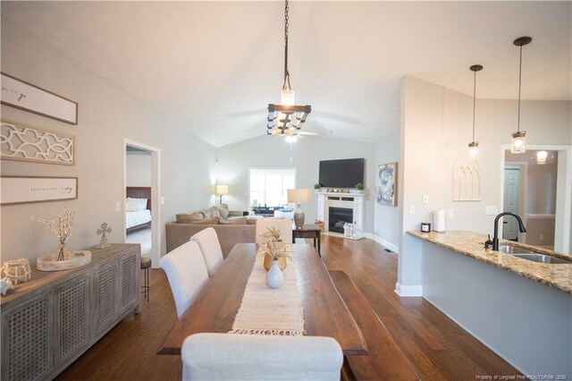 3119 Metthame Dr, Fayetteville, NC 28306 - dining room with vaulted ceiling, dark wood-type flooring, a fireplace, and ceiling fan
