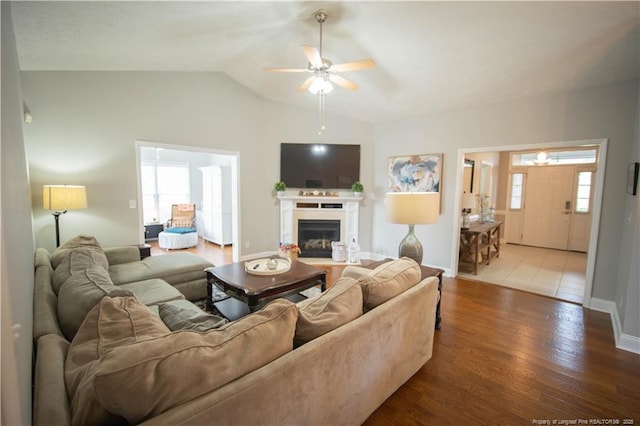 3119 Metthame Dr, Fayetteville, NC 28306 - living room featuring a ceiling fan, vaulted ceiling, wood finished floors, and a fireplace