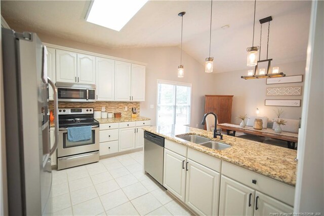 3119 Metthame Dr, Fayetteville, NC 28306 - kitchen with stainless steel appliances, lofted ceiling, decorative backsplash, white cabinets, and light tile patterned floors