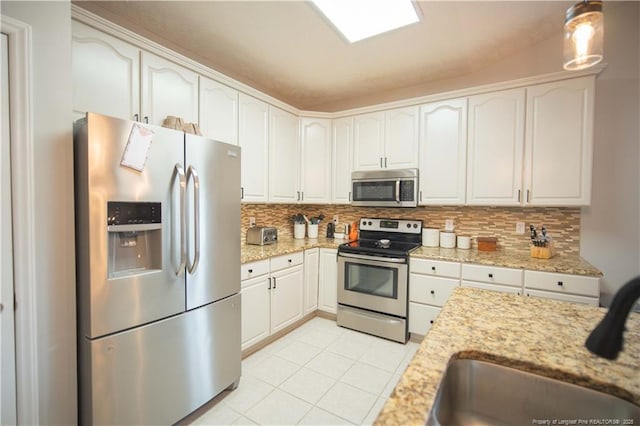 3119 Metthame Dr, Fayetteville, NC 28306 - kitchen featuring stainless steel appliances, decorative backsplash, white cabinetry, and light stone counters