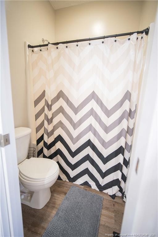 3119 Metthame Dr, Fayetteville, NC 28306 - full bath with wood finished floors and a shower with shower curtain