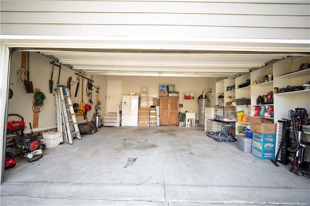 3119 Metthame Dr, Fayetteville, NC 28306 - garage featuring gas water heater and white refrigerator with ice dispenser
