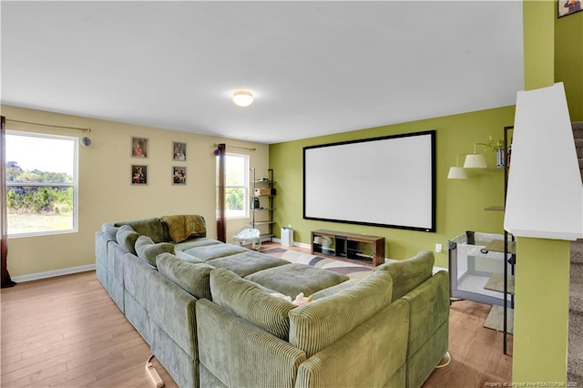 home theater with wood finished floors and baseboards