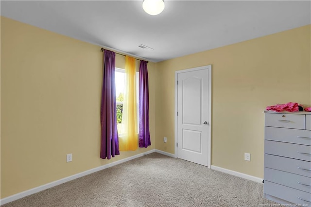 unfurnished bedroom featuring baseboards and carpet floors