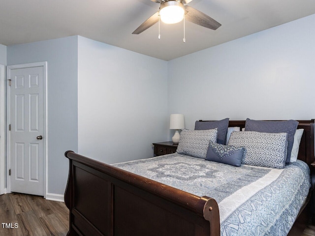 bedroom with wood finished floors, a ceiling fan, and baseboards