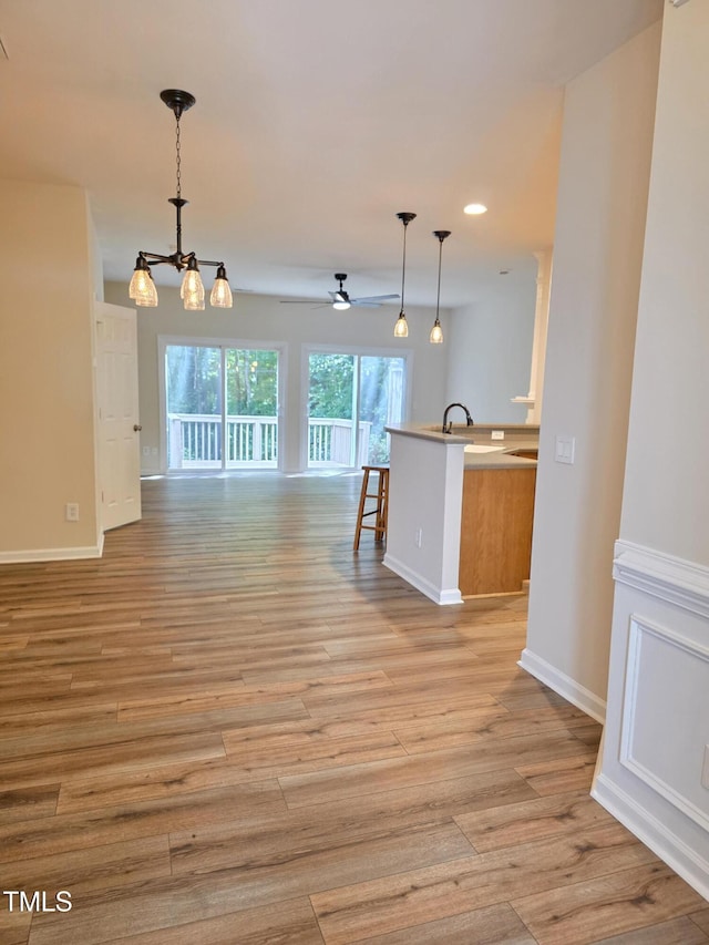 4206 Camden Woods Ct, Raleigh, NC 27612 - kitchen with open floor plan, baseboards, light wood-type flooring, hanging light fixtures, and recessed lighting