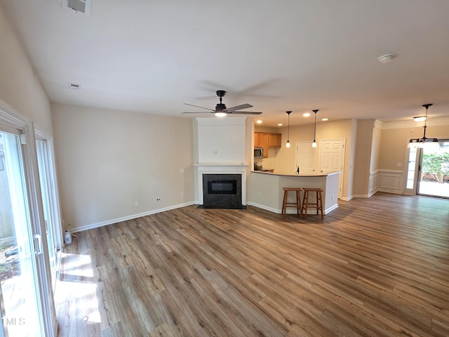 4206 Camden Woods Ct, Raleigh, NC 27612 - unfurnished living room with a ceiling fan, wood finished floors, recessed lighting, a fireplace with flush hearth, and baseboards