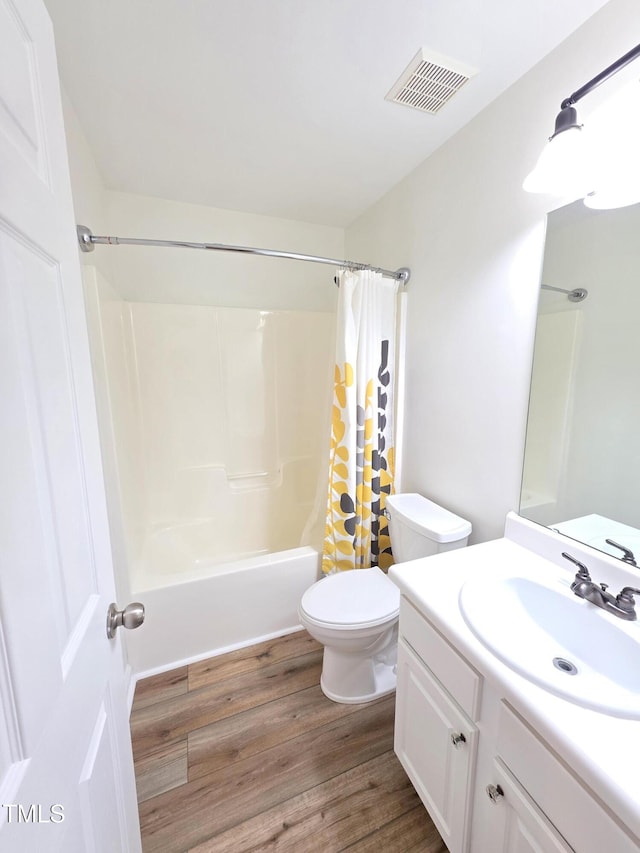 4206 Camden Woods Ct, Raleigh, NC 27612 - full bath featuring shower / tub combo with curtain, vanity, toilet, and wood finished floors