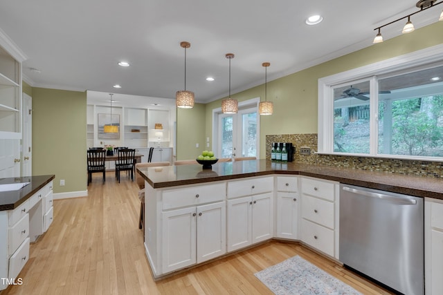 kitchen with stainless steel dishwasher, light wood-type flooring, backsplash, a peninsula, and ornamental molding