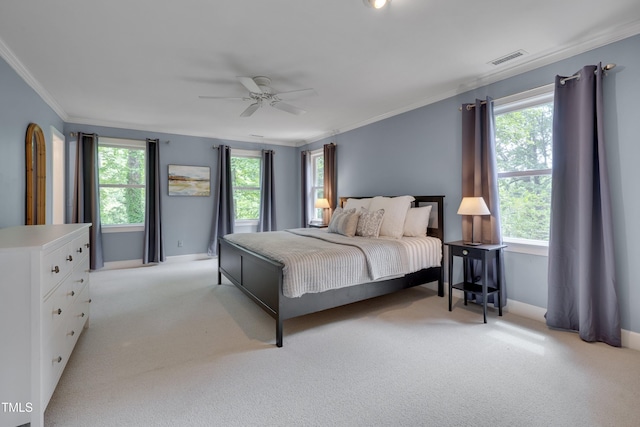 bedroom featuring light carpet, ornamental molding, baseboards, and ceiling fan