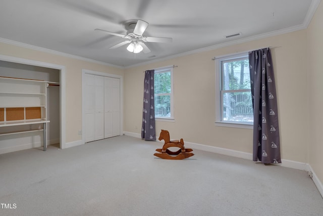 unfurnished bedroom featuring carpet floors, two closets, ornamental molding, and baseboards