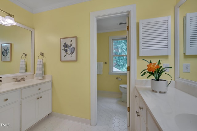 bathroom featuring vanity, ornamental molding, toilet, tile patterned floors, and baseboards