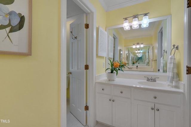 bathroom featuring crown molding, a chandelier, and vanity