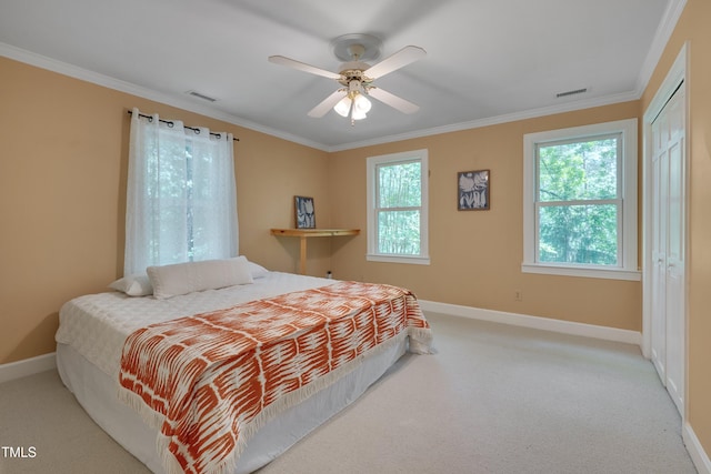 carpeted bedroom featuring baseboards, multiple windows, and ornamental molding
