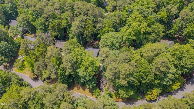 aerial view of property and surrounding area featuring a forest