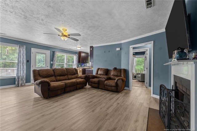 5712 Icarus Cir, Fayetteville, NC 28304 - living room with light wood-style floors, ceiling fan, baseboards, healthy amount of natural light, and a textured ceiling