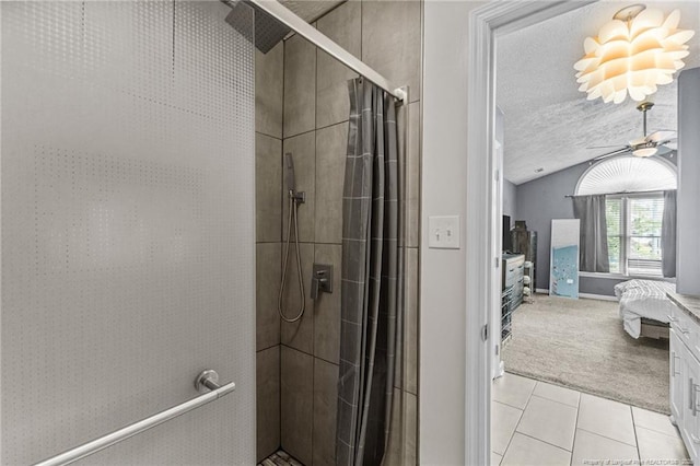 5712 Icarus Cir, Fayetteville, NC 28304 - ensuite bathroom featuring a stall shower, vaulted ceiling, tile patterned flooring, a textured ceiling, and a ceiling fan