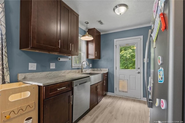 5712 Icarus Cir, Fayetteville, NC 28304 - kitchen with stainless steel appliances, light wood-style floors, crown molding, dark brown cabinets, and a sink