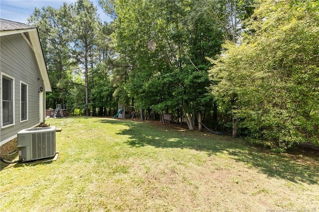 5712 Icarus Cir, Fayetteville, NC 28304 - view of grassy yard with central AC unit and view of scattered trees