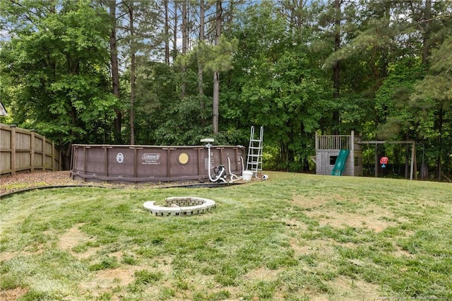 5712 Icarus Cir, Fayetteville, NC 28304 - view of yard with a playground, a fire pit, and view of scattered trees