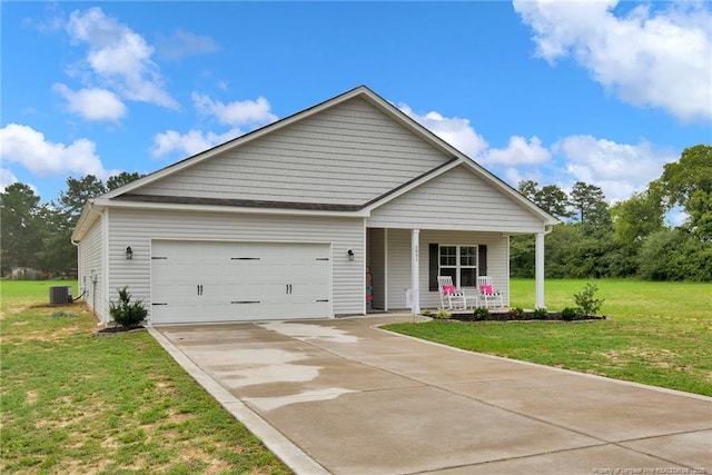 5831 James Allen Ln, Stedman, NC 28391 - view of front of house featuring a porch, central AC, a garage, concrete driveway, and a front lawn