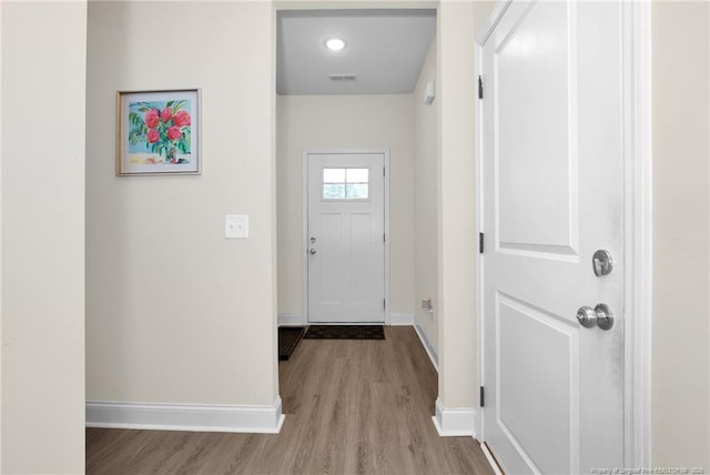 5831 James Allen Ln, Stedman, NC 28391 - doorway to outside featuring wood finished floors and baseboards