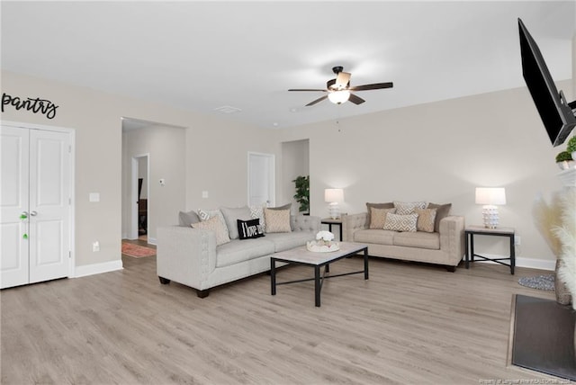 5831 James Allen Ln, Stedman, NC 28391 - living room featuring a ceiling fan, light wood-style floors, and baseboards