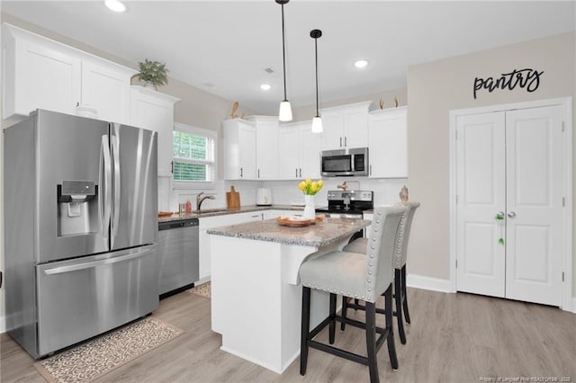 5831 James Allen Ln, Stedman, NC 28391 - kitchen with appliances with stainless steel finishes, light wood-style flooring, white cabinetry, and recessed lighting