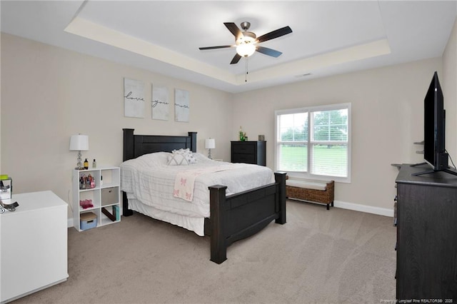 5831 James Allen Ln, Stedman, NC 28391 - bedroom featuring a raised ceiling, light carpet, baseboards, and ceiling fan
