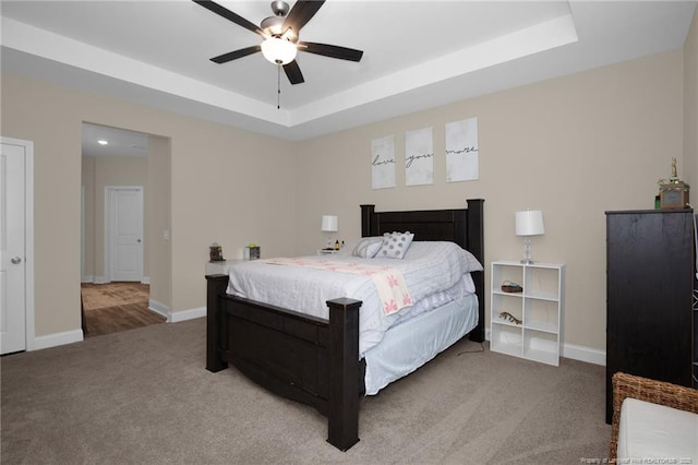 5831 James Allen Ln, Stedman, NC 28391 - bedroom featuring light carpet, a raised ceiling, and baseboards