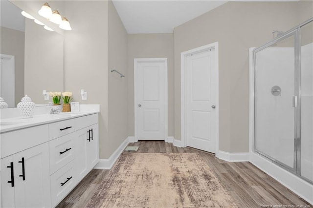 5831 James Allen Ln, Stedman, NC 28391 - bathroom featuring wood finished floors, a shower stall, double vanity, and baseboards