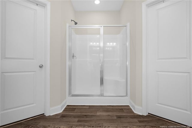 5831 James Allen Ln, Stedman, NC 28391 - bathroom featuring baseboards, a stall shower, and wood finished floors