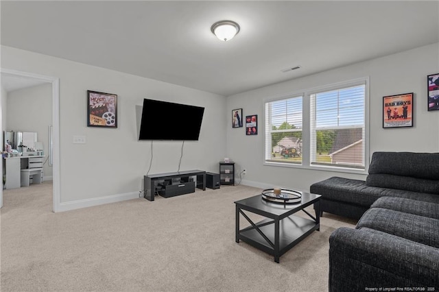 living room featuring carpet and baseboards