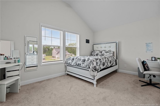 bedroom with light colored carpet, vaulted ceiling, and baseboards