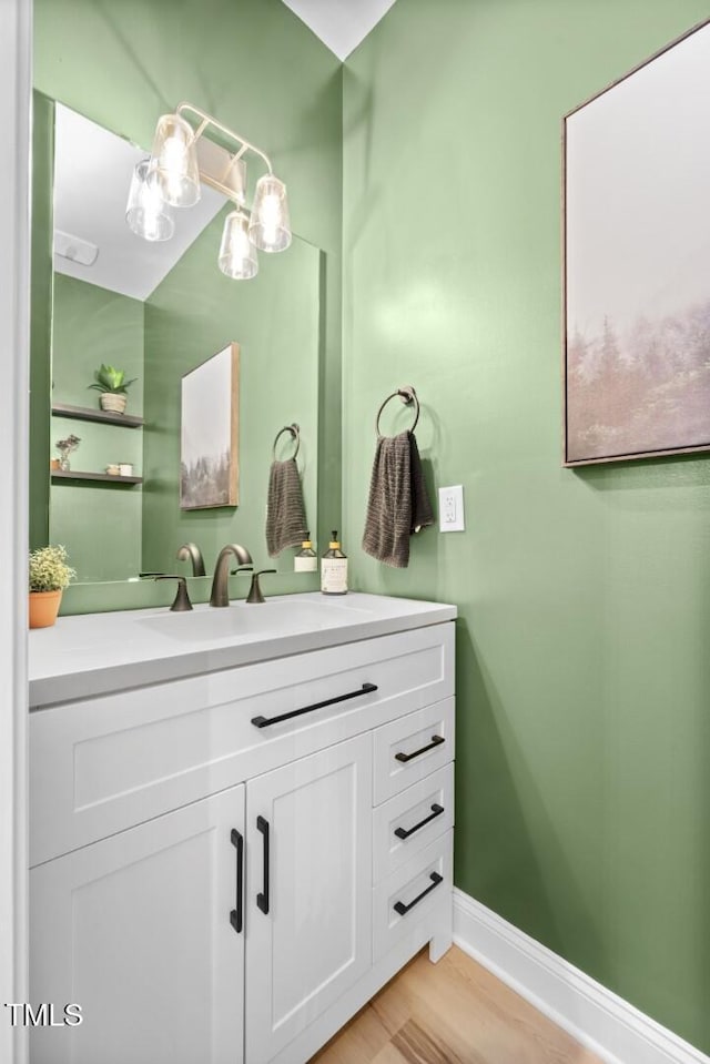 220 Purslane Dr, Franklinton, NC 27525 - bathroom with vanity, baseboards, and wood finished floors
