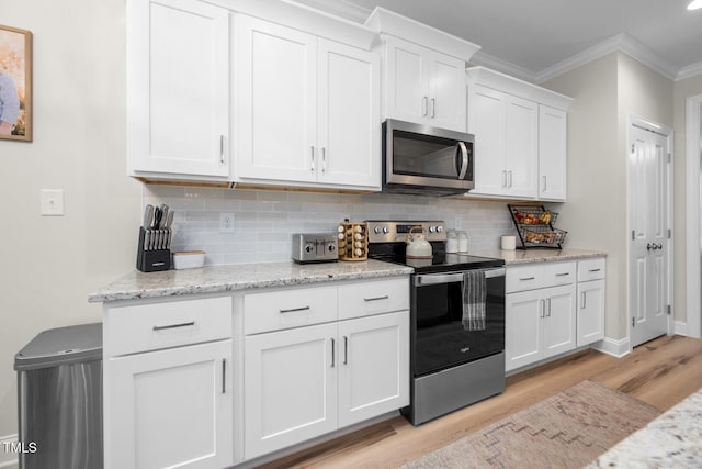 220 Purslane Dr, Franklinton, NC 27525 - kitchen with appliances with stainless steel finishes, light wood-type flooring, crown molding, backsplash, and white cabinets