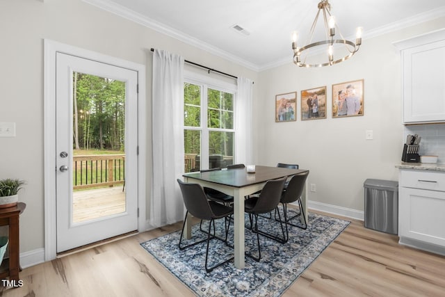 220 Purslane Dr, Franklinton, NC 27525 - dining room featuring a chandelier, light wood-style floors, crown molding, and baseboards