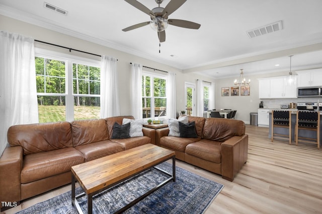 220 Purslane Dr, Franklinton, NC 27525 - living room with light wood finished floors, a chandelier, ceiling fan, and ornamental molding