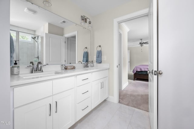 220 Purslane Dr, Franklinton, NC 27525 - ensuite bathroom with double vanity, a tile shower, ceiling fan, marble look tile flooring, and baseboards