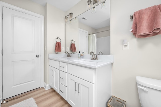 220 Purslane Dr, Franklinton, NC 27525 - bathroom with toilet, wood finished floors, and double vanity