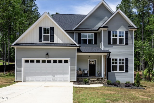 220 Purslane Dr, Franklinton, NC 27525 - view of front of property featuring covered porch, driveway, a shingled roof, board and batten siding, and a front yard