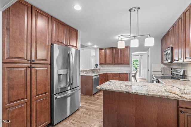 208 Silk Hope Dr, Cary, NC 27519 - kitchen with stainless steel appliances, light wood-style flooring, backsplash, a peninsula, and recessed lighting