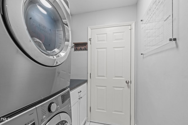 208 Silk Hope Dr, Cary, NC 27519 - laundry room featuring stacked washer / dryer and cabinet space