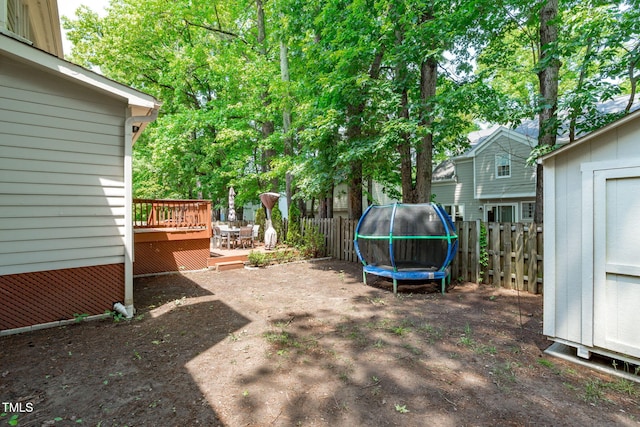 208 Silk Hope Dr, Cary, NC 27519 - fenced backyard with a trampoline, a wooden deck, and a storage unit
