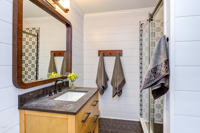 bathroom with crown molding, vanity, a shower stall, and wooden walls